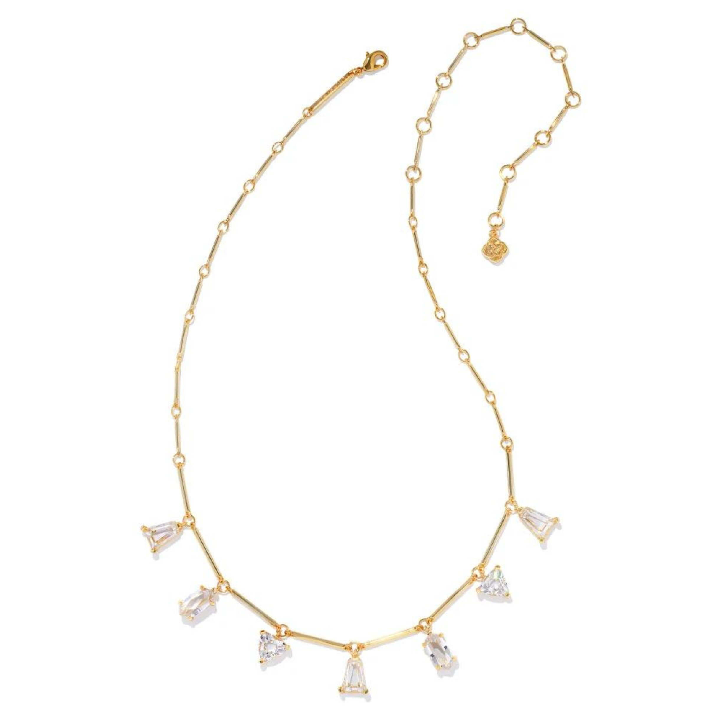 Gold chain necklace with white crystal charms in different shapes. This necklace is pictured on a white background.