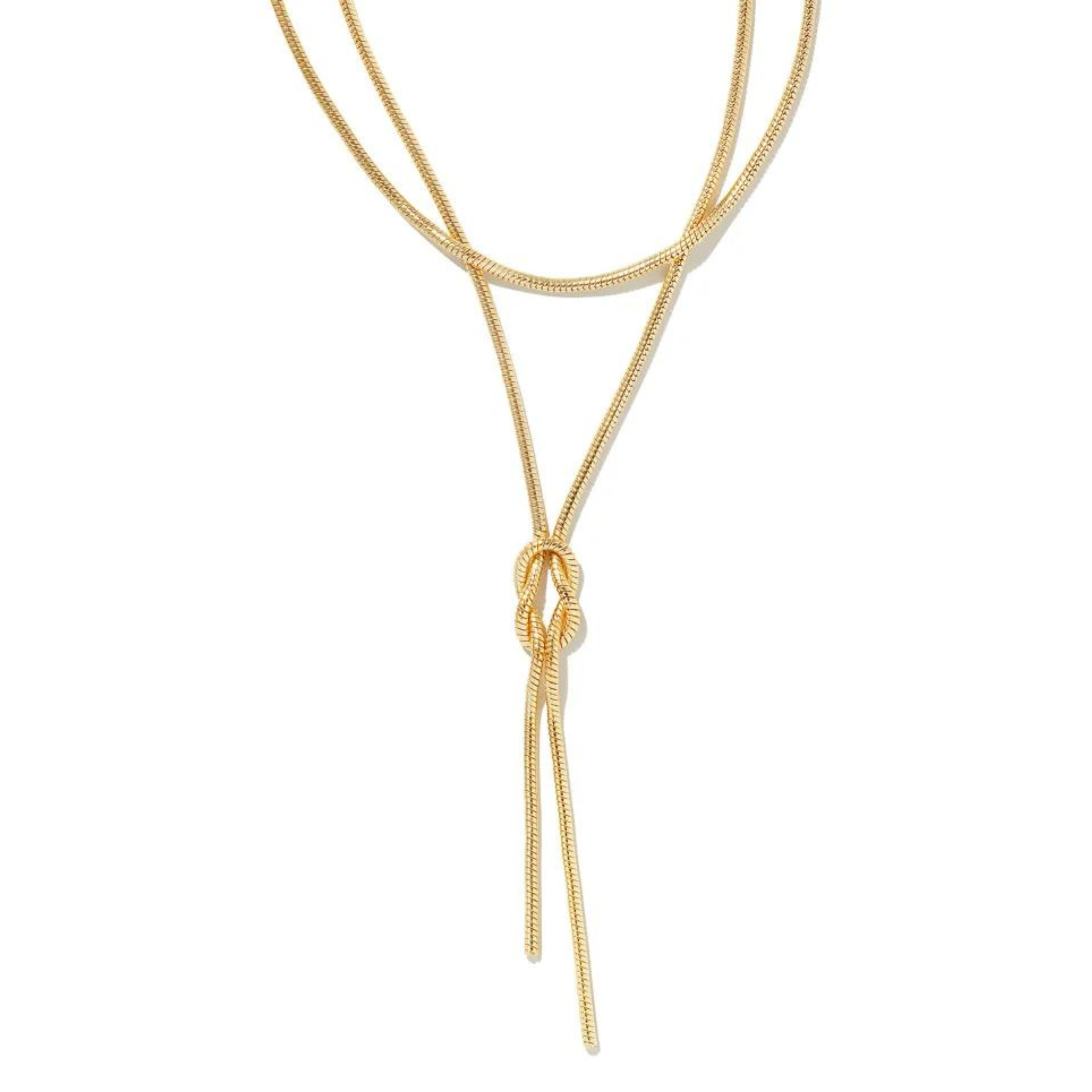 Gold necklace with two layers and has a tied knot towards the bottom. This necklace is pictured on a white background. 