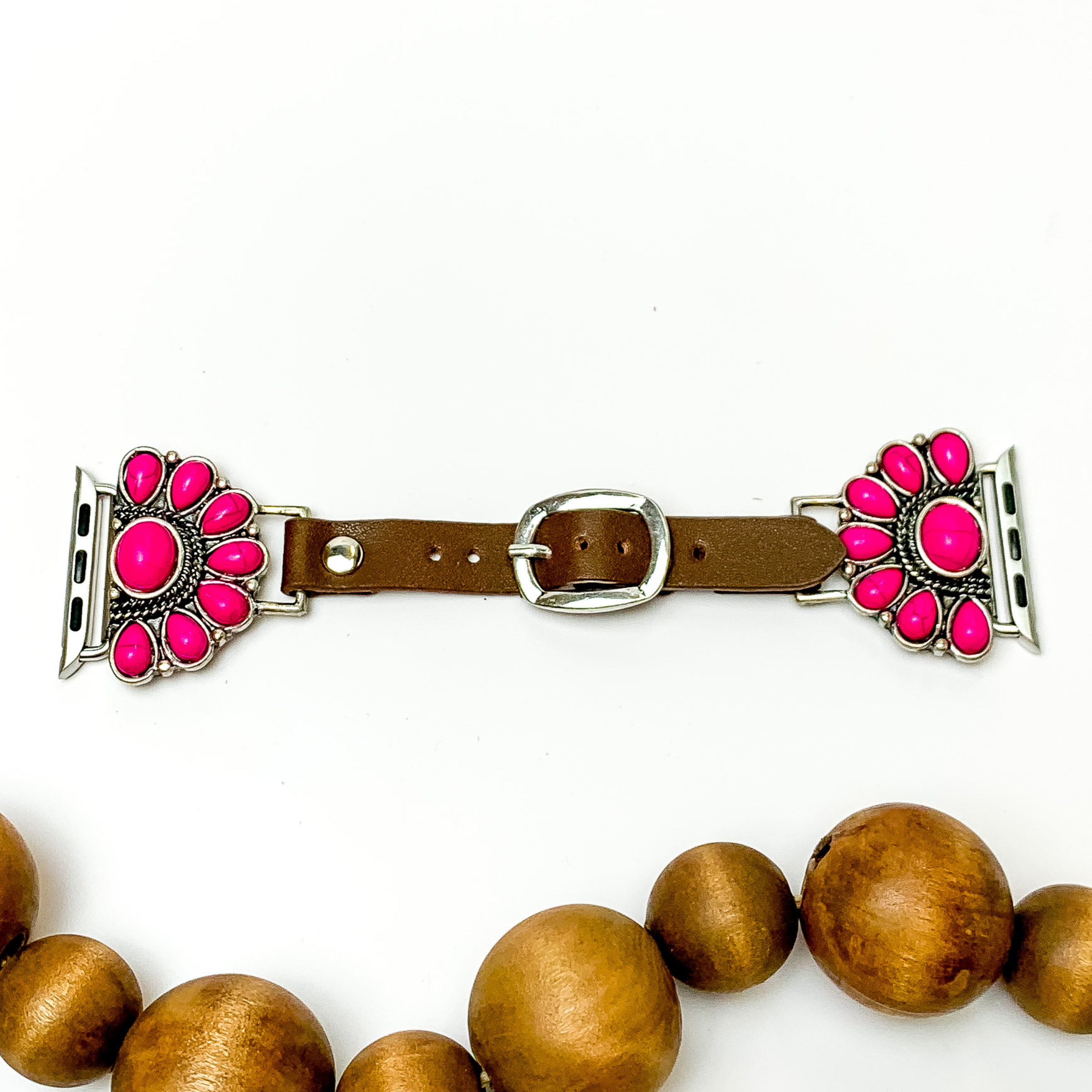 Dark Brown watch band with half, stone cluster pendants and Apple watch band acessories. The pendants include fuchsia stones. This watch band is pictured on a white background with brown beads below the band. 