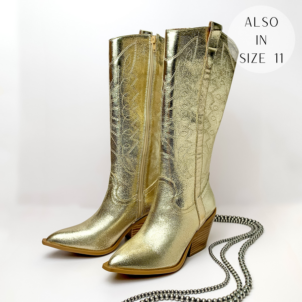 Metallic gold cowboy boots with gold western stitching and tan heel. These boots are pictured on a white background with silver beads on the right side of the boots.