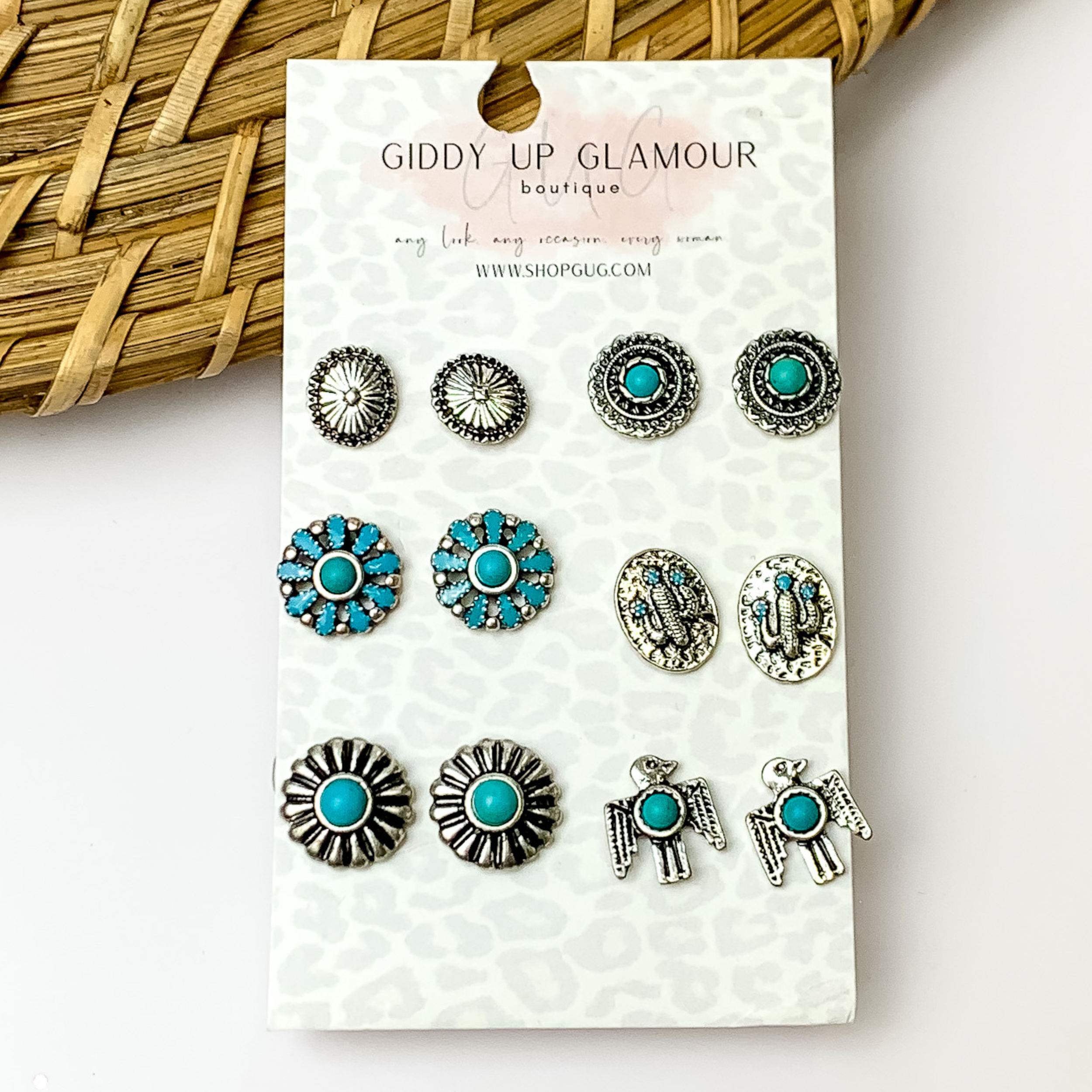 Set of six turquoise and silver designed stud earrings. With a white background.