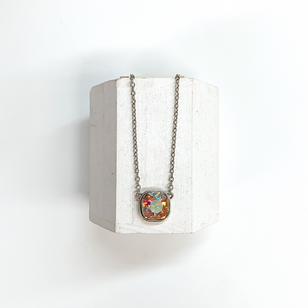 This is a silver chain necklace with an AB cushion cut crystal pendant.  This necklace is taken on a white block and on a white background.