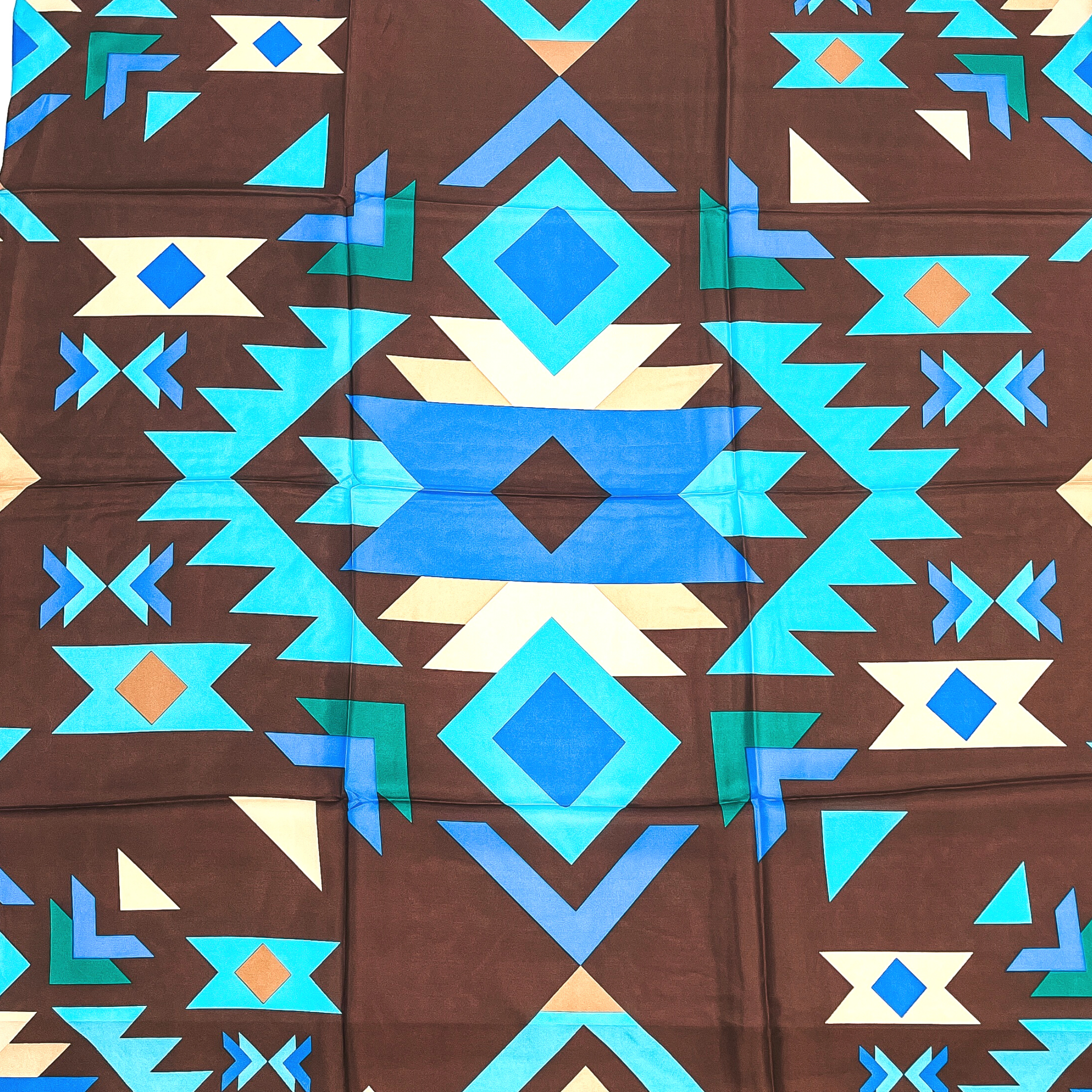 This is a tribal print in brown, beige, turquoise, and blue with various geometric shapes.