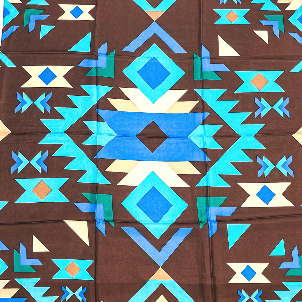 This is a tribal print in brown, beige, turquoise, and blue with various geometric shapes.