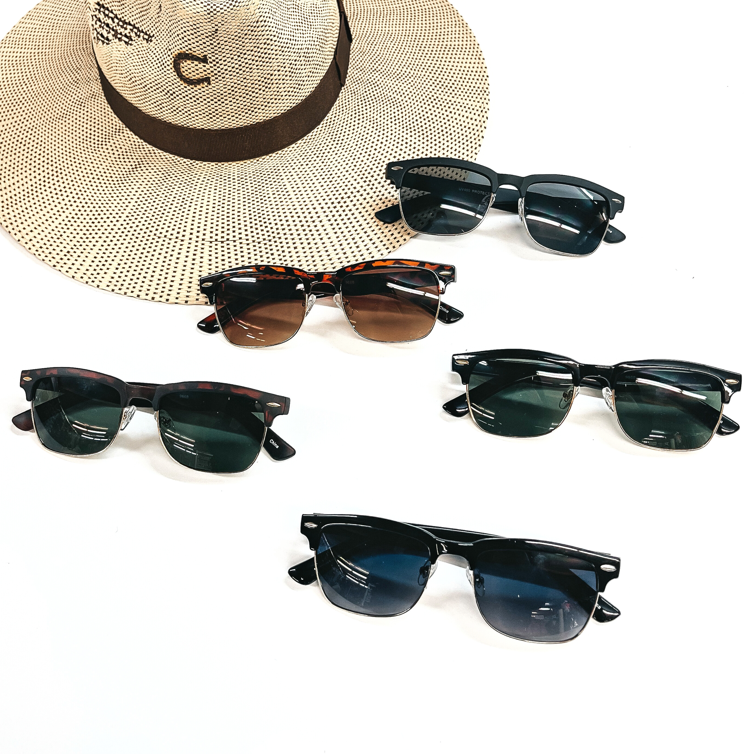 These are five pairs of sunglasses in different colors/prints and lenses.  There is black shine/black matte, tortuoise print in shine/matte. These sunglasses are  taken on a white background with an ivory/brown straw hat in the back as decor. 