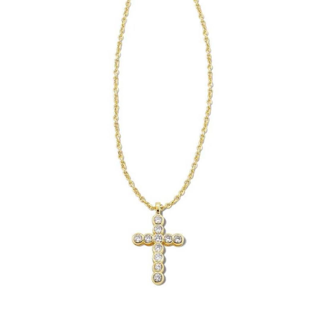 Gold necklace with cross pendant with white crystals, pictured on a white background.