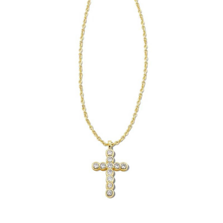 Gold necklace with cross pendant with white crystals, pictured on a white background.
