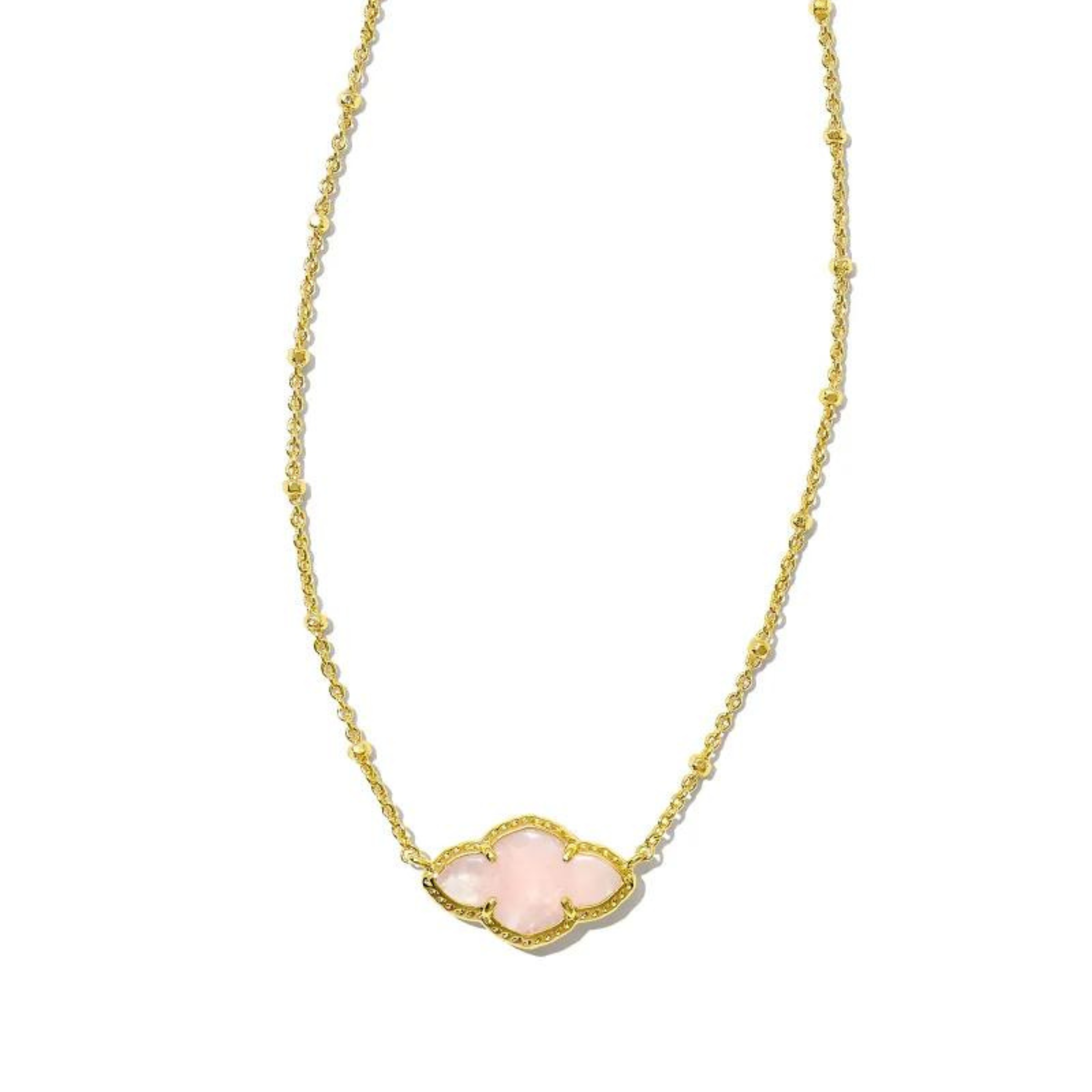 Gold necklace with a quatrefoil pendant with a rose quartz stone, pictured on a white bacground.