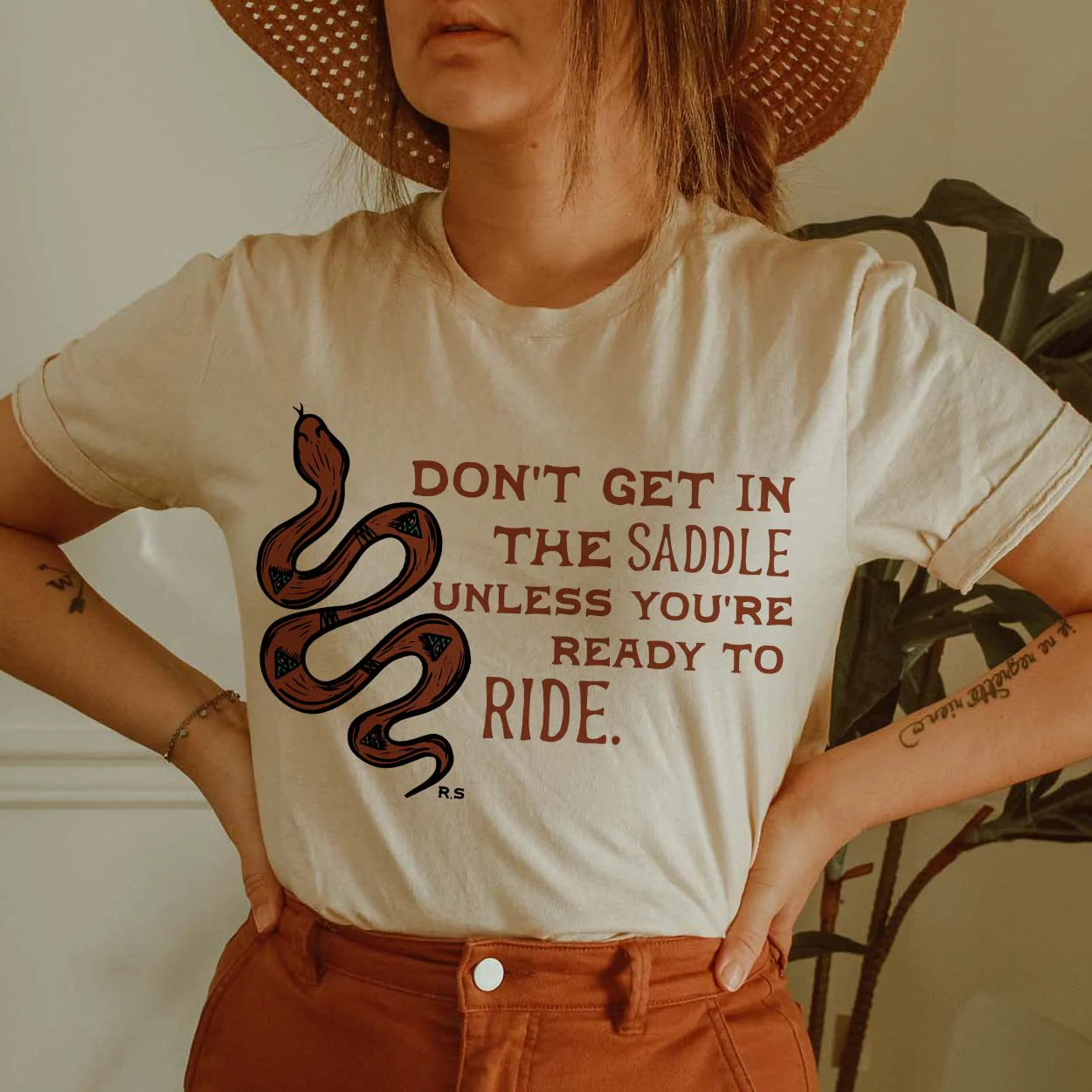 Online Exclusive | Don't Get in the Saddle Graphic Tee in Cream - Giddy Up Glamour Boutique