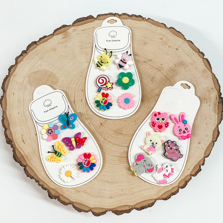 Three sets of six croc clips pictured on a piece of wood on a white background. 