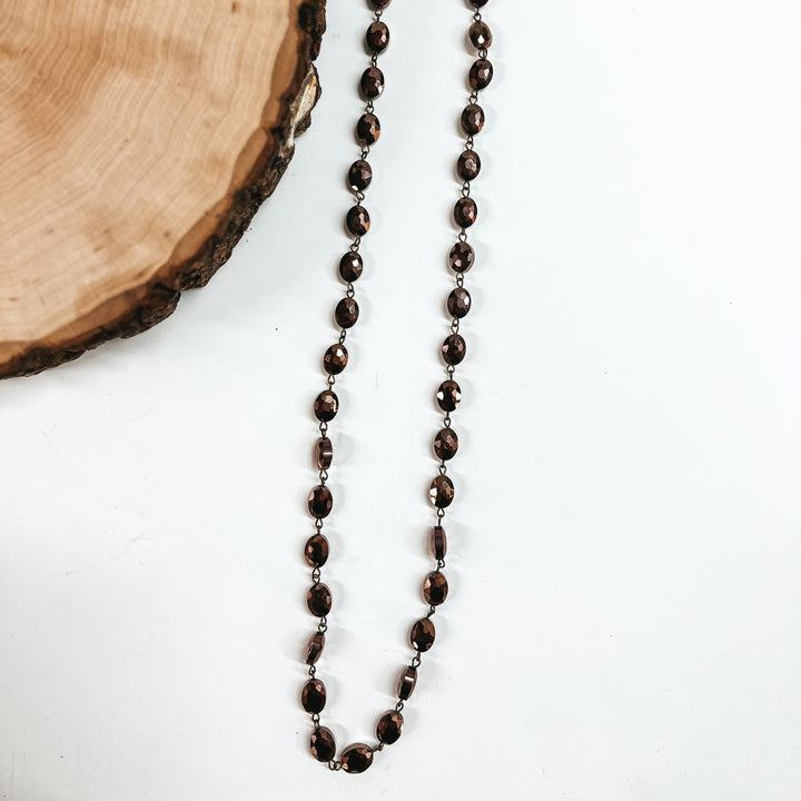 Pink Panache | Long Chocolate Flat Oval Crystal Beaded Necklace with Bronze Links - Giddy Up Glamour Boutique