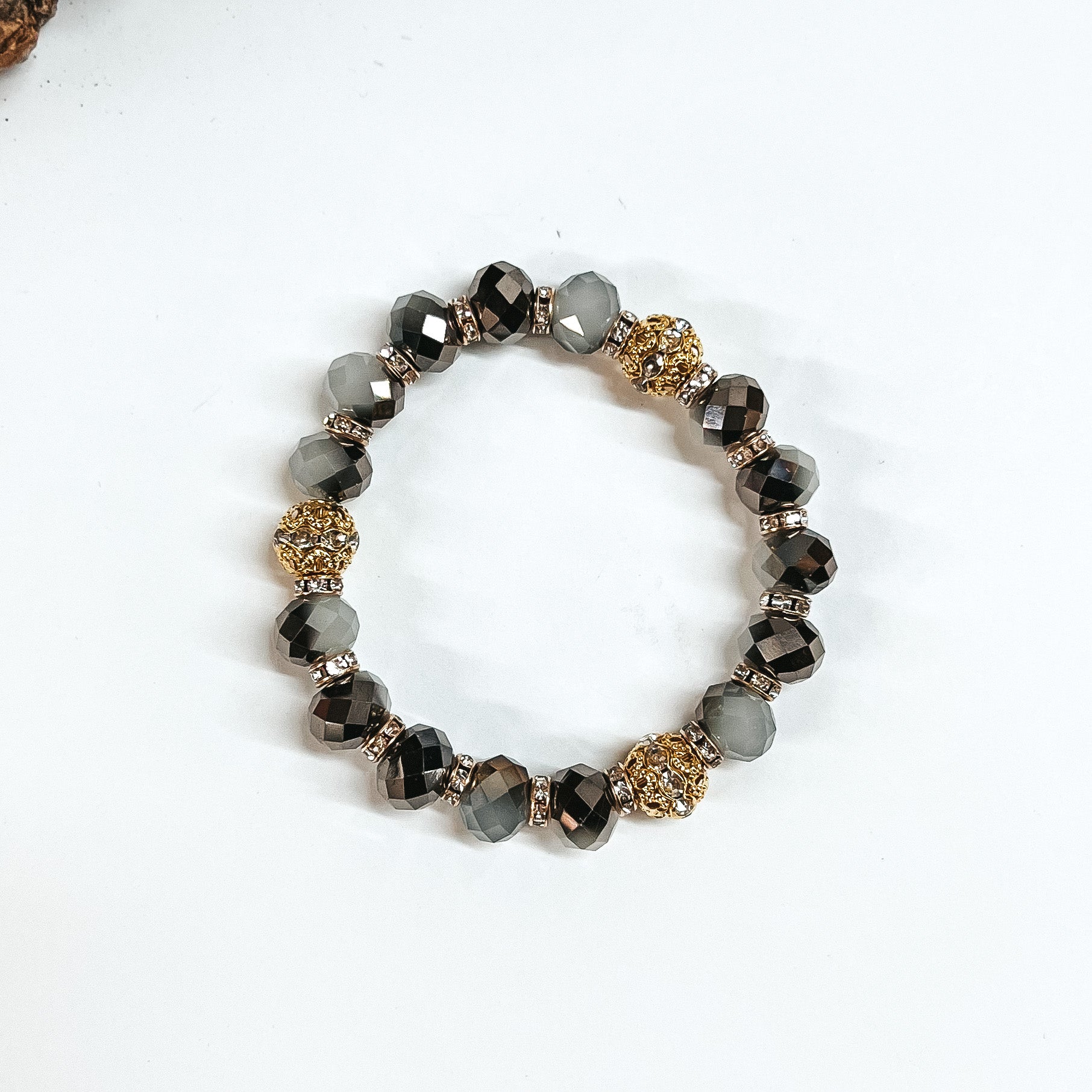 This is black mix crystal beaded bracelets with gold spacers.  The gold spacers have clear crystals in them and there are three gold and  crystals beads.This bracelet is taken on white background.
