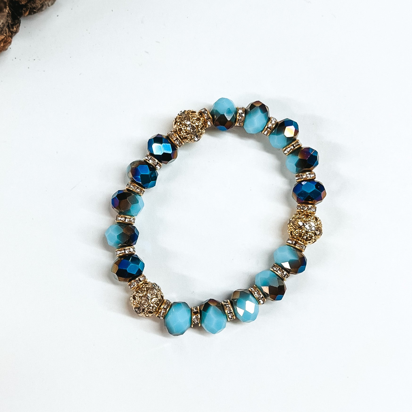 This is blue mix crystal beaded bracelets with gold spacers.  The gold spacers have clear crystals in them and there are three gold and  crystals beads.This bracelet is taken on white background.