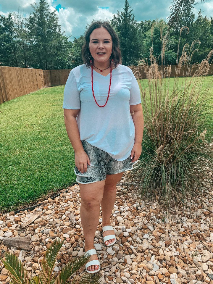 Making Hissstory Ruffle Hem Shorts with Pom Pom Trim in Snakeskin - Giddy Up Glamour Boutique